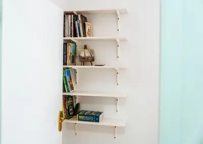 a book shelf filled with books in a room at Large Stylish 2-bedroom apt near ski road, 5 min to Gondola & Bar Street in Bansko