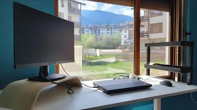 a computer monitor sitting on a desk in front of a window at Large Stylish 2-bedroom apt near ski road, 5 min to Gondola & Bar Street in Bansko