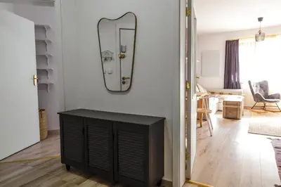a living room with a mirror on the wall at Large Stylish 2-bedroom apt near ski road, 5 min to Gondola & Bar Street in Bansko