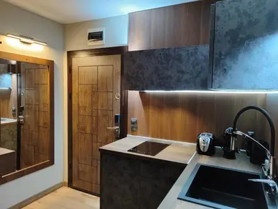 a kitchen with a sink and a wooden door at View apartment #2 in Bansko