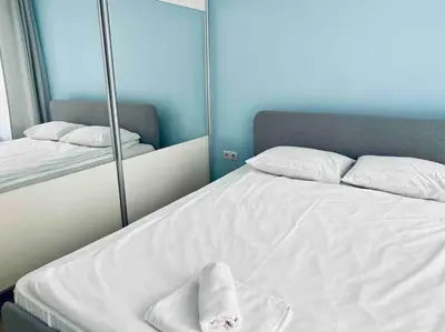 a bedroom with a bed with towels on it at Modern Turquoise Apartment/free WiFi in Sofia