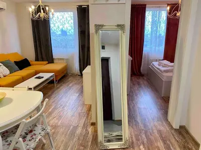 a living room with a mirror and a couch at Stylish Magenta Apartment - terrace & free parking in Sofia