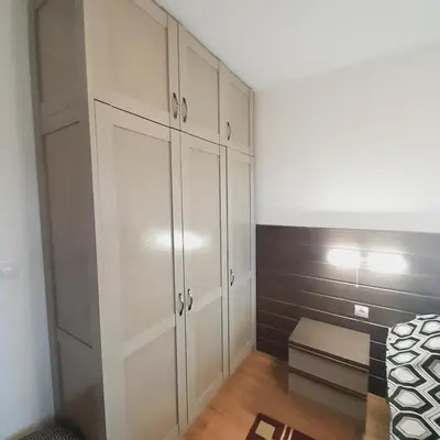 a bedroom with white cabinets and a bed at VIP Apartments Belvedere with terrace K105 in Bansko