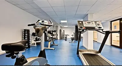 a gym with several tread machines and a treadmill at VIP Apartments Belvedere with terrace K105 in Bansko