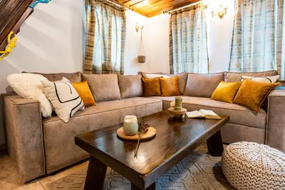 a living room with a couch and a coffee table at Slona, Heritage Home in Old Town Plovdiv in Plovdiv