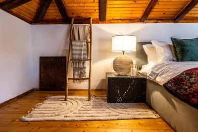 a bedroom with a bed and a table with a lamp at Slona, Heritage Home in Old Town Plovdiv in Plovdiv