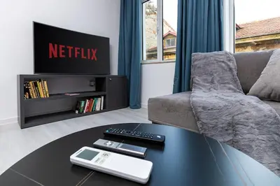 a living room with a table and a couch at Kapana Beat 2-bedroom apt. Top Center in Plovdiv
