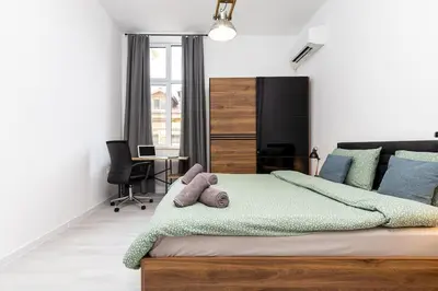 a bedroom with a bed with a teddy bear on it at Kapana Beat 2-bedroom apt. Top Center in Plovdiv
