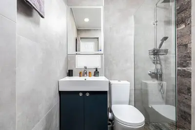 a bathroom with a toilet and a sink and a shower at Kapana Beat 2-bedroom apt. Top Center in Plovdiv