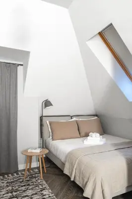 a bedroom with a bed and a skylight at 8th Hill Apartments in Plovdiv
