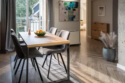 a dining room table with chairs and a bowl of fruit on it at 8th Hill Apartments in Plovdiv