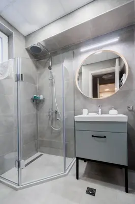 a bathroom with a shower and a sink and a mirror at 8th Hill Apartments in Plovdiv
