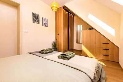 a bedroom with a bed with two bags on it at Hills View Central Apartment in Plovdiv