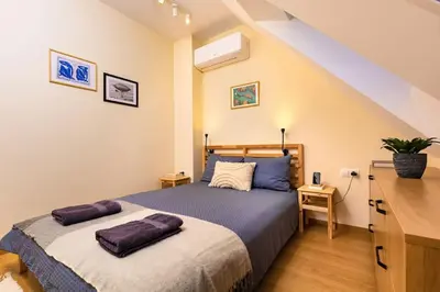 a bedroom with a bed and a dresser in a room at Hills View Central Apartment in Plovdiv