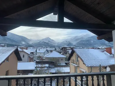 a view from a balcony of a town with snow covered roofs at Marand Boutique Apartments in Bansko