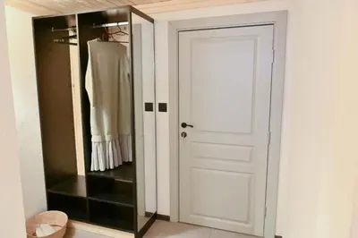 a closet with a white door and a mirror at Marand Boutique Apartments in Bansko