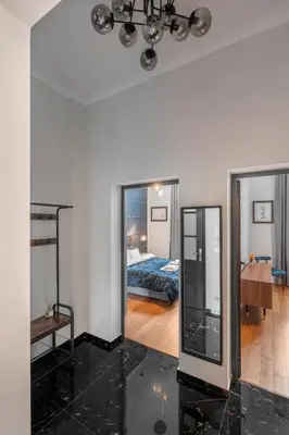 a living room with a bed and a mirror at NEW High-End 2BR Apartment with Parking in Sofia