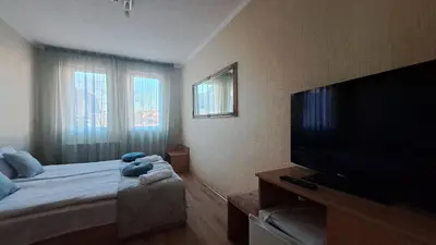 a bedroom with a bed with a teddy bear on it at REAL Guest House in Bansko
