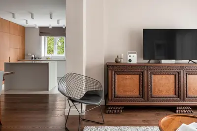 a living room with a television and a chair at NEW High-End Designer 3BR Central Apt Free Parking in Sofia