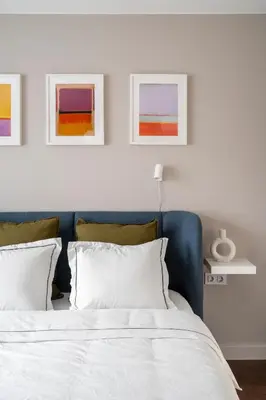 a bed with two pillows and two paintings on the wall at NEW High-End Designer 3BR Central Apt Free Parking in Sofia