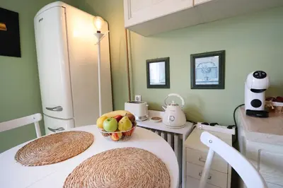 a kitchen with a table with a bowl of fruit on it at Spacious and Central Vintage - Modern Apartment in Sofia