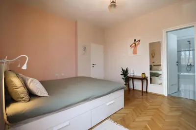 a bedroom with a bed and a bathroom at Spacious and Central Vintage - Modern Apartment in Sofia