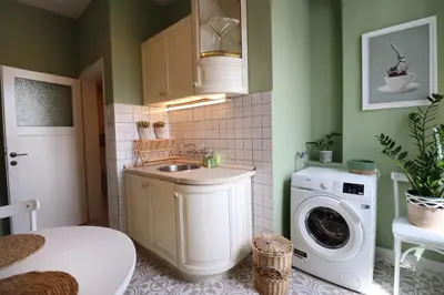 a bathroom with a sink and a washing machine at Spacious and Central Vintage - Modern Apartment in Sofia