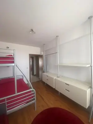 a bedroom with two bunk beds and a red couch at Neon Gondola apartment in Bansko