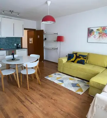 a living room with a green couch and a table at Neon Gondola apartment in Bansko
