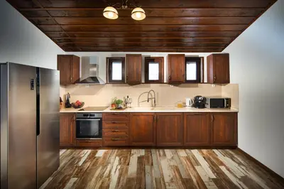 a kitchen with wooden cabinets and a stainless steel refrigerator at Vila Toplika in Kara Agach