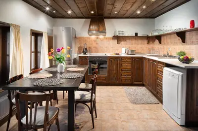 a kitchen with a table and chairs in a kitchen at Vila Toplika in Kara Agach
