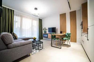 a living room with a couch and a table at ARHEYA 3 apart АРХЕЯ 3 апартамент за гости in Karlovo
