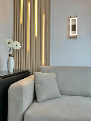 a living room with a couch and a vase with flowers at City Modern & Classy Apartment for 4 Guests & Parking in Sofia
