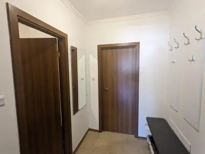 a bathroom with a wooden door and a mirror at Sapphire Mountain 1 in Bansko
