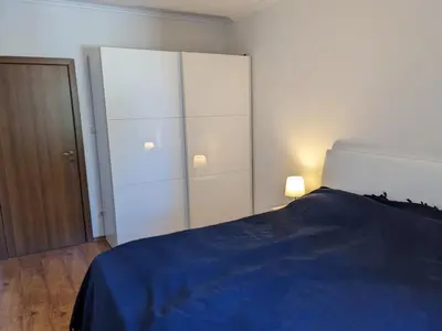 a bedroom with a blue bed and a white cabinet at Sapphire Mountain 1 in Bansko