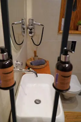 a bathroom with a white sink and a toilet at Bansko Nest in Bansko