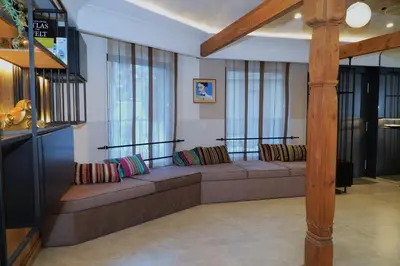 a living room with a couch and some windows at Bansko Nest in Bansko
