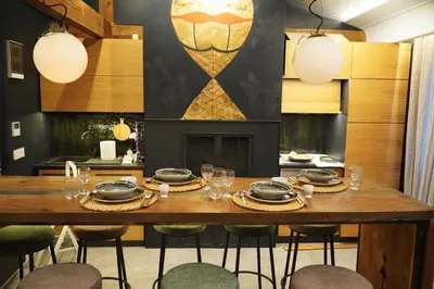 a dining room with a wooden table and chairs at Bansko Nest in Bansko