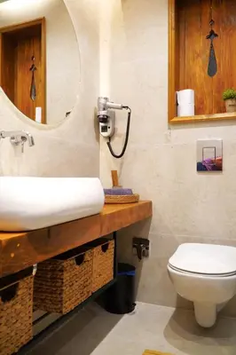 a bathroom with a sink and a toilet and a mirror at Bansko Nest in Bansko