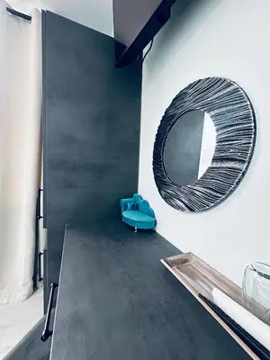 a mirror on the wall of a room with a table at VELI HOUSE VELINGRAD/ ВелиХаус Къща за гости Велинград in Velingrad