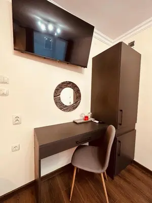 a desk with a chair and a mirror on a wall at VELI HOUSE VELINGRAD/ ВелиХаус Къща за гости Велинград in Velingrad