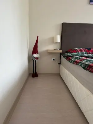 a santa claus standing in a corner of a bedroom at Borovets Gardens Funky Fresh Studio by Joro in Borovets