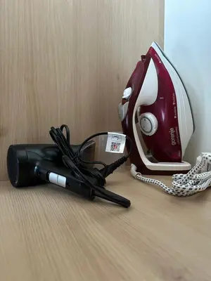 a hair dryer and a phone on a table at Borovets Gardens Funky Fresh Studio by Joro in Borovets