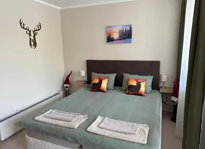 a bedroom with a bed with two pillows at Borovets Gardens Funky Fresh Studio by Joro in Borovets