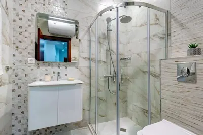 a bathroom with a glass shower and a sink at N.Joy Holiday Apartment 534 by Oak Residence in Smolyan