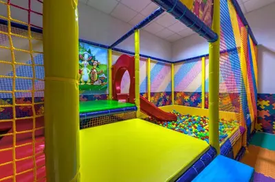 a childrens play room with a slide and play equipment at N.Joy Holiday Apartment 534 by Oak Residence in Smolyan