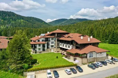 an aerial view of a large house with cars parked in a parking lot at N.Joy Holiday Apartment 534 by Oak Residence in Smolyan