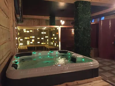 a hot tub in the middle of a patio at night at N.Joy Holiday Apartment 413 by Sunny Hills in Pamporovo