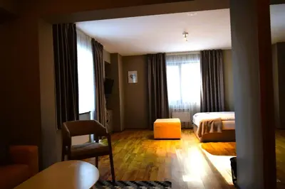 a hotel room with a bed and a chair at N.Joy Holiday Apartment 417 by Sunny Hills in Pamporovo