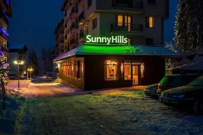 a building with a sign that reads summary kills at N.Joy Holiday Apartment 417 by Sunny Hills in Pamporovo
